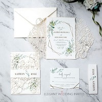 elegant ivory laser cut wedding invitation with greenery pattern around framed wording EWDM015