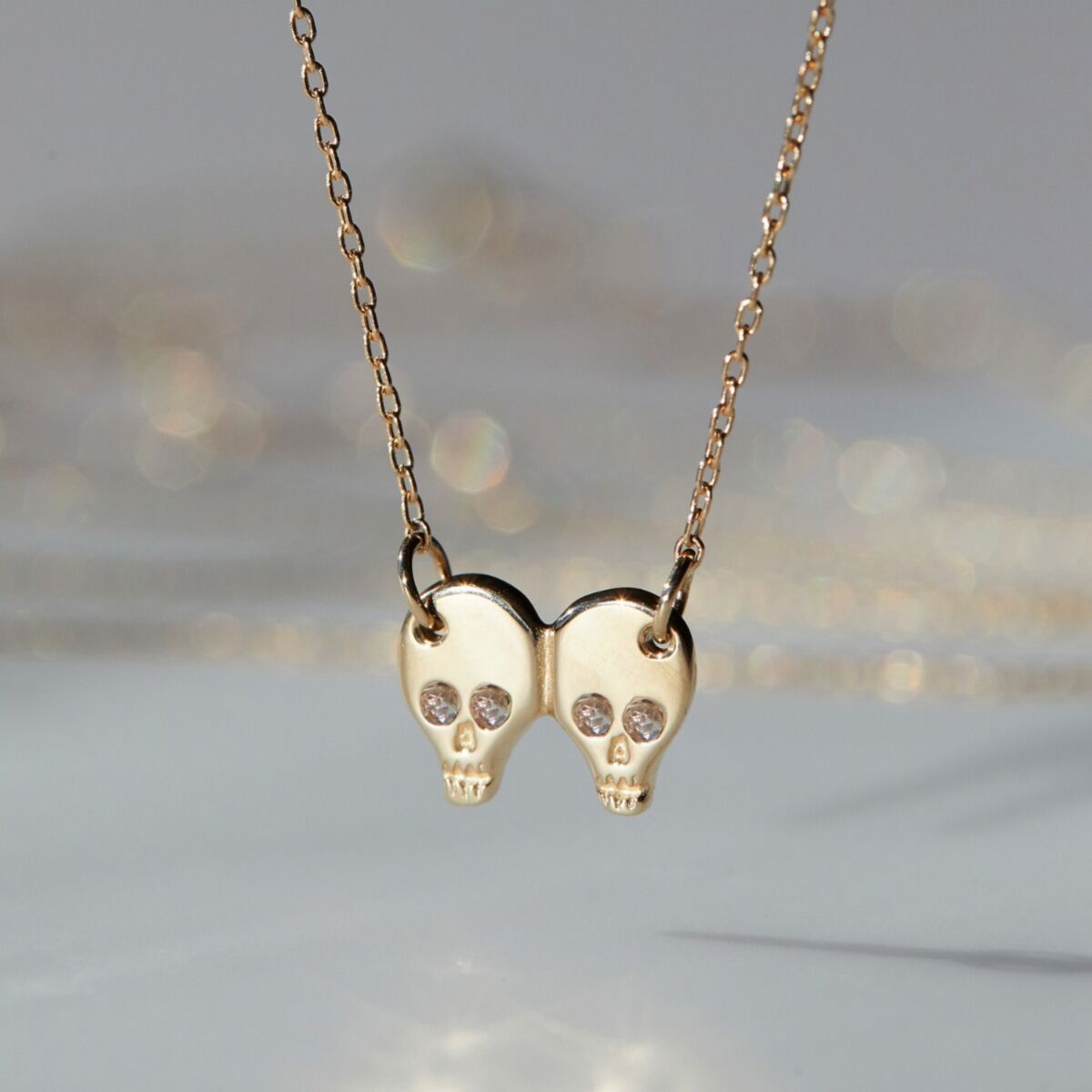 gold double skull necklace
