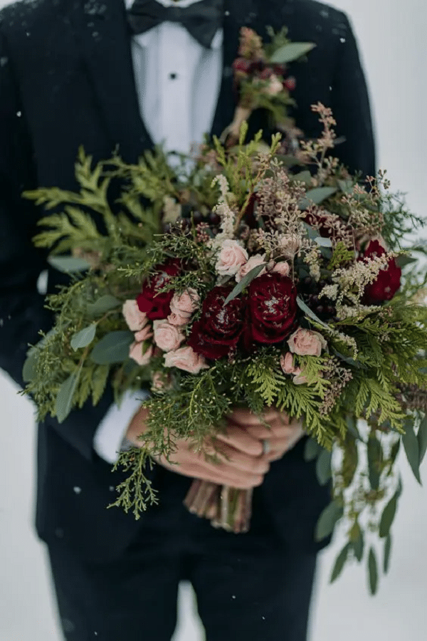 chic christmas wedding bouquet of greenery eucalyptus blush and burgundy blooms