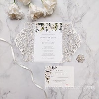 elegnat ivory and white flowers and greenery pattern laser cut invitation
