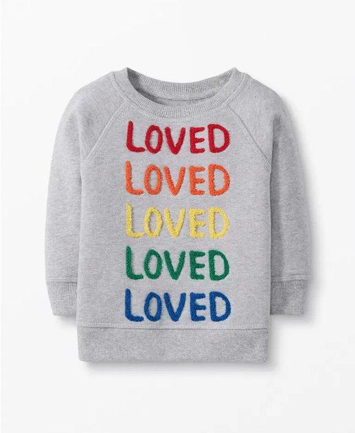 Grey kids sweatshirt with the word "loved" in red, orange, yellow, green, and blue